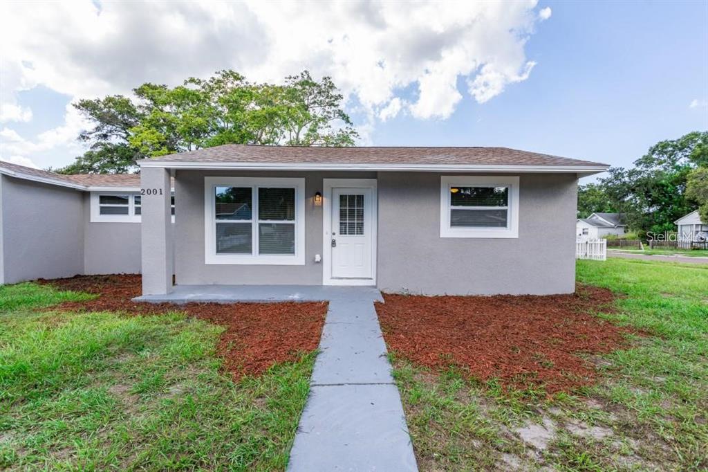 A single-story gray house with a white front door and a concrete walkway — 2001 45TH STREET S, ST PETERSBURG, FL