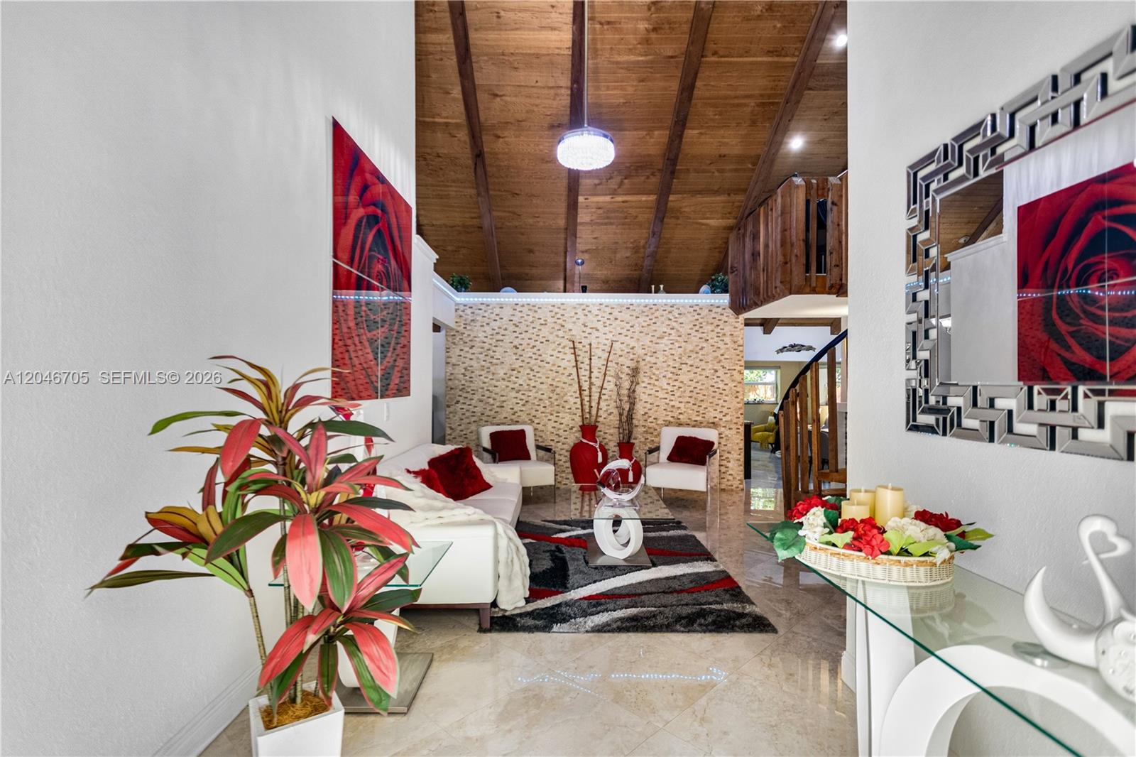 A living room features a vaulted wood ceiling, tiled floors, and red accent decor — 2620 Buttonwood Ave, Miramar FL 33025, MIRAMAR, FL