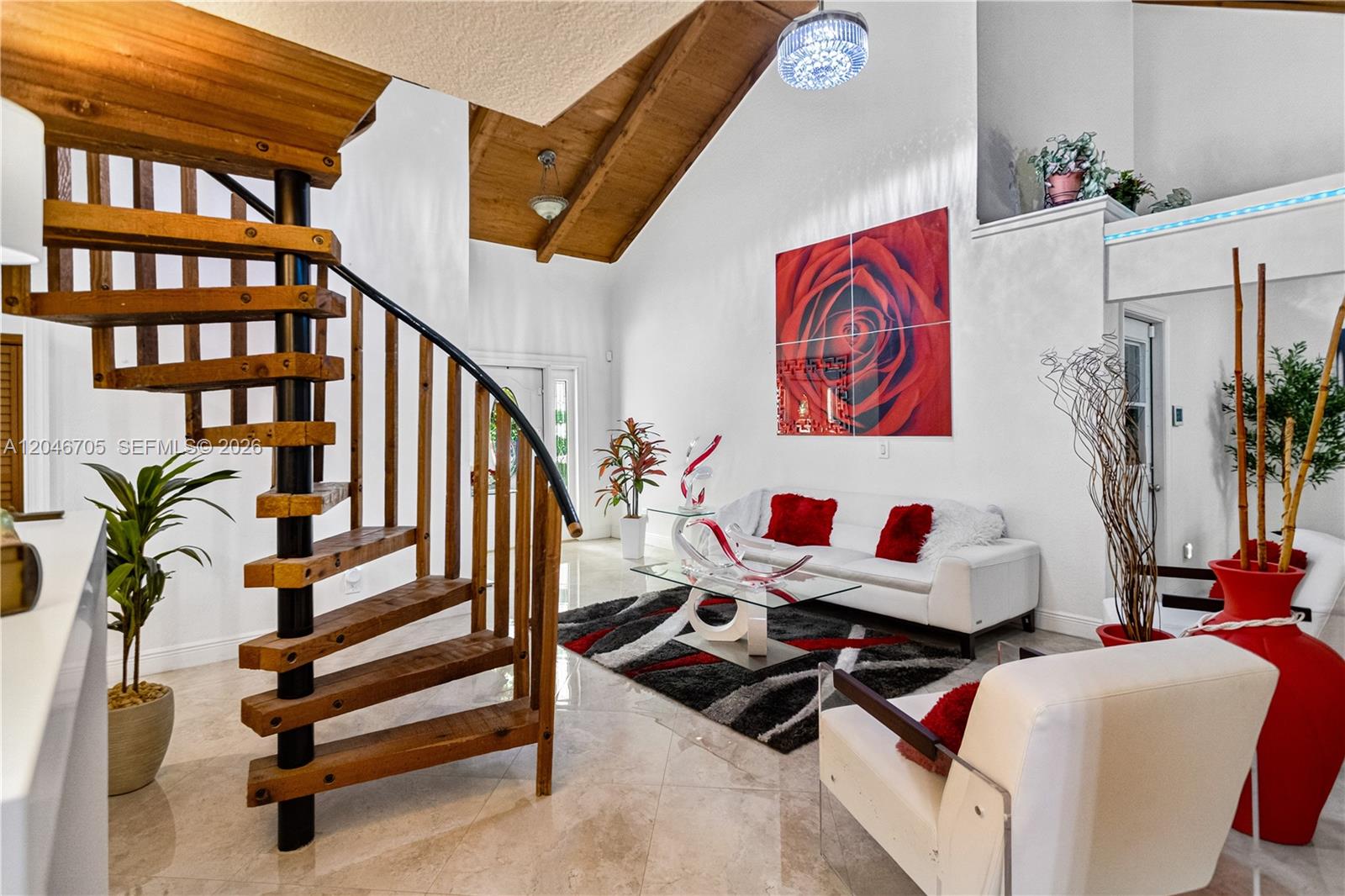 A living room features a spiral staircase, vaulted wood-paneled ceiling, and modern white furniture — 2620 Buttonwood Ave, Miramar FL 33025, MIRAMAR, FL
