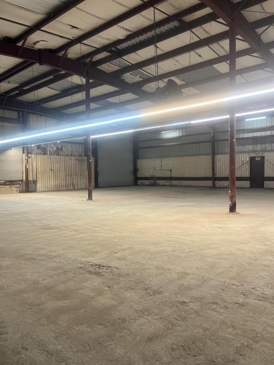 An empty industrial warehouse space features concrete floors, metal walls, and exposed ceiling beams — 210 Industrial Drive, Islamorada FL 33036, ISLAMORADA, FL