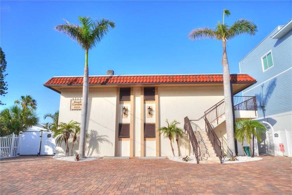 An aerial view of a sandy beach, ocean, and coastal residential buildings — 8535 BLIND PASS DRIVE UNIT 103, TREASURE ISLAND, FL