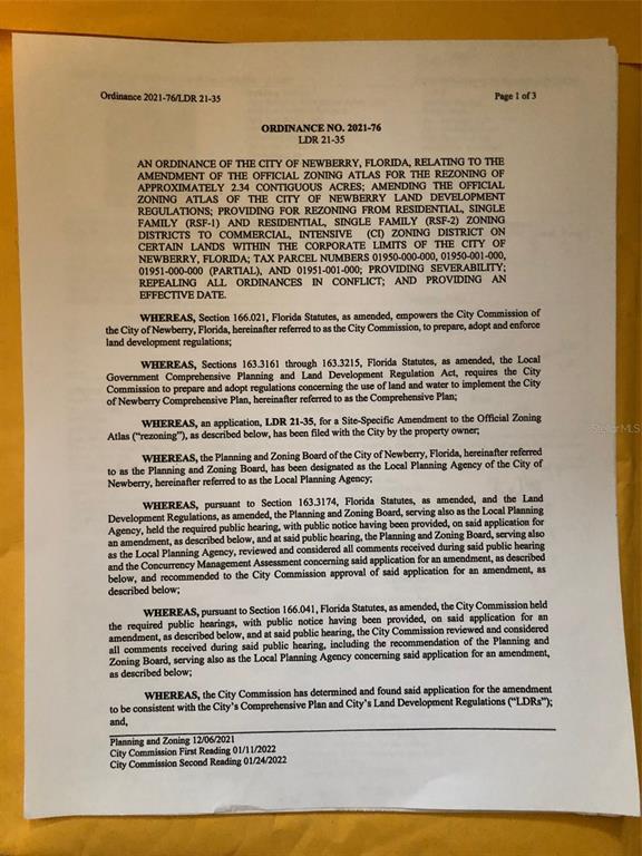 This is a photograph of a printed legal ordinance document regarding a zoning amendment — 24809 W NEWBERRY ROAD, NEWBERRY, FL