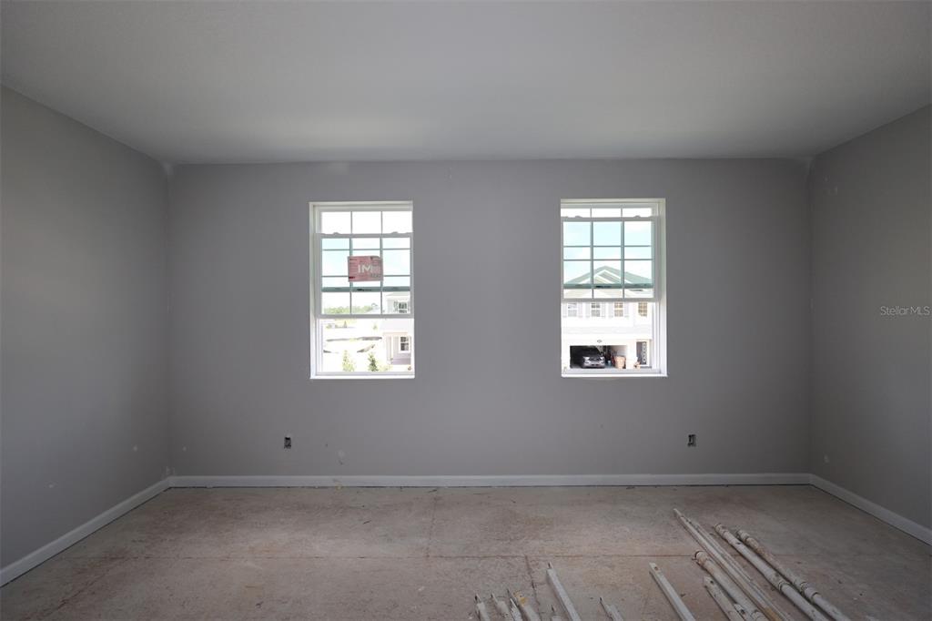 A kitchen with dark cabinets, a white island, and light wood flooring — 2685 GREAT HERON AVENUE, ST CLOUD, FL