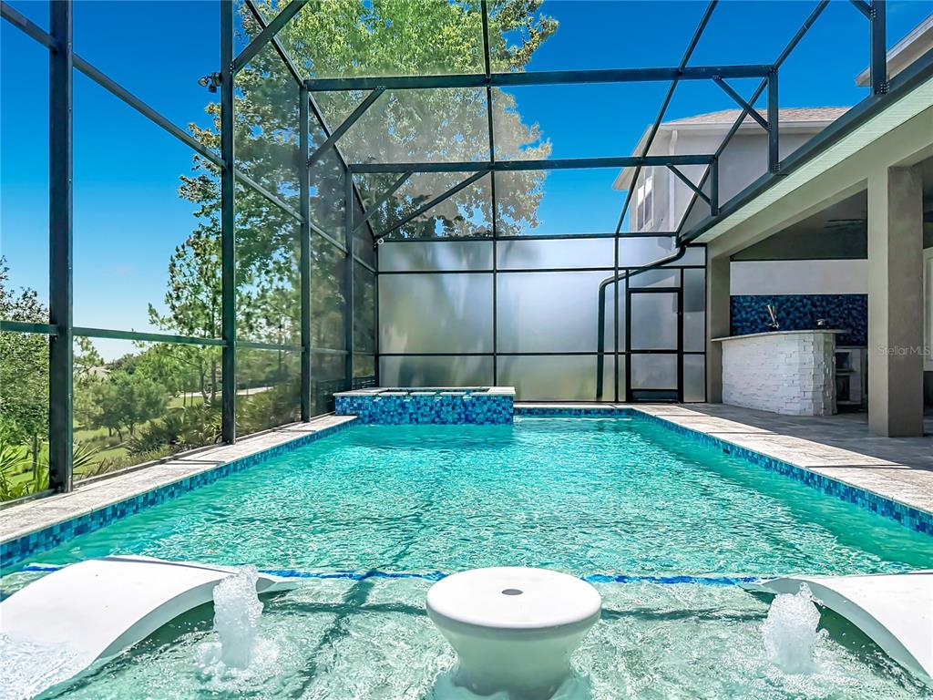 A two-story house with a paved driveway, a garage, and a covered front porch — 14591 BLACK QUILL DRIVE, WINTER GARDEN, FL
