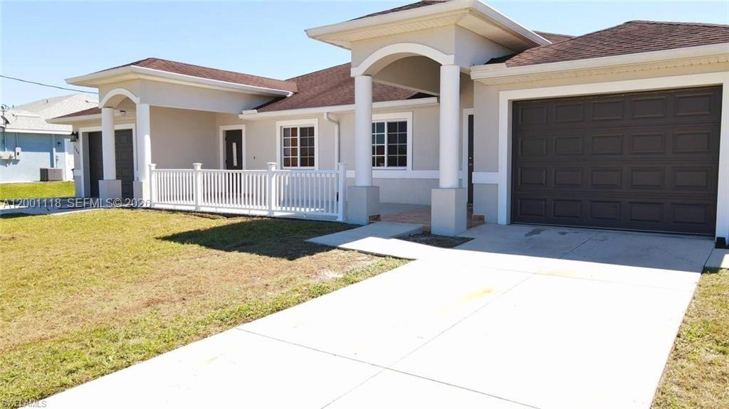 A single-story house features a white porch railing, a brown roof, and a garage — 152 Pullman St # 152, Lehigh Acres FL 33974, LEHIGH ACRES, FL