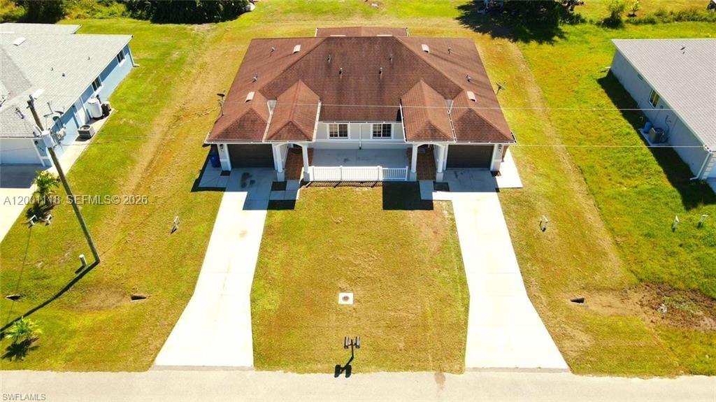 An aerial view shows a duplex house with two garages and a shared front yard — 152 Pullman St # 152, Lehigh Acres FL 33974, LEHIGH ACRES, FL