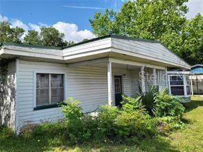 A single-story house with white horizontal siding and a covered front porch — 5371 WARM SPRINGS AVENUE, WILDWOOD, FL