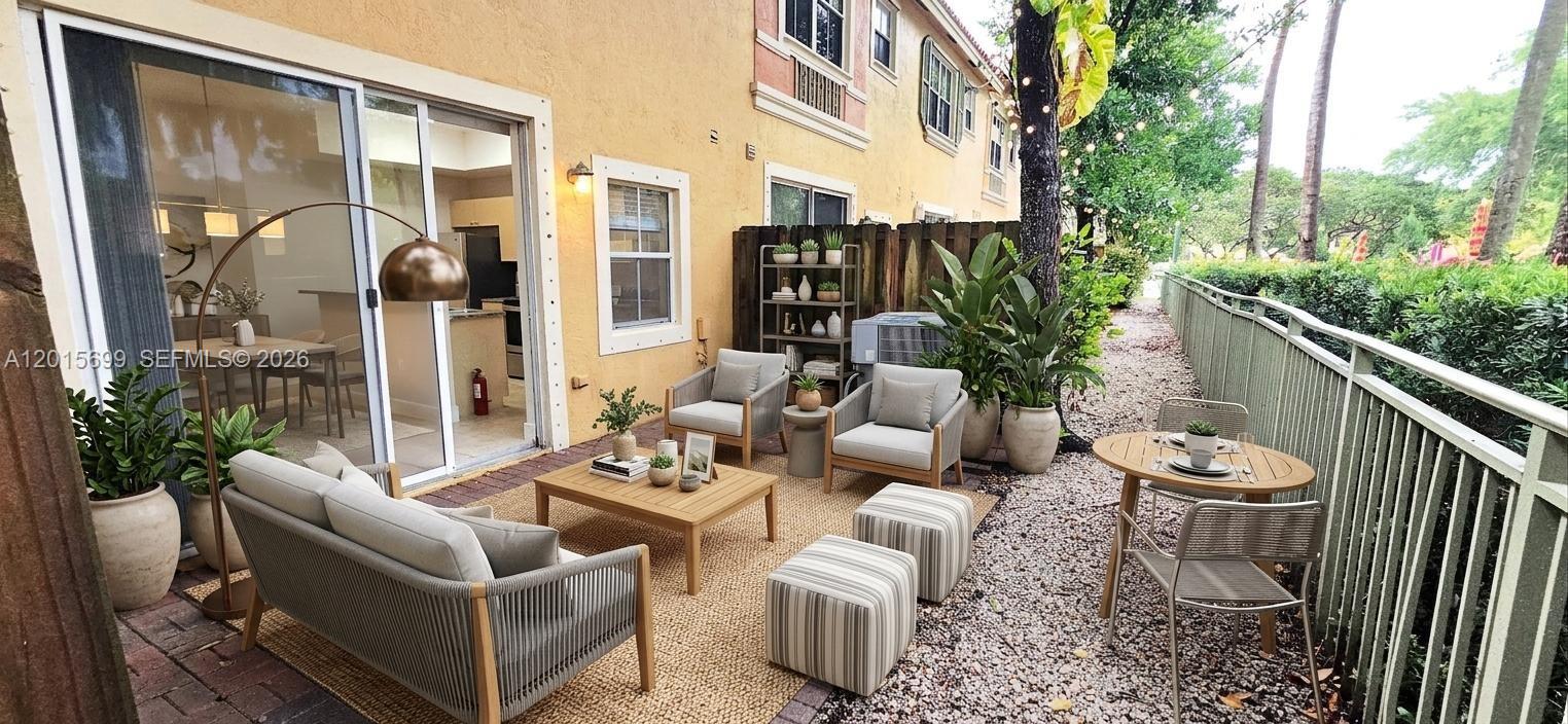 A patio features outdoor furniture, a gravel ground, and a sliding glass door entrance — 4950 Tradewinds Ter # 505, Dania Beach FL 33312, DANIA BEACH, FL