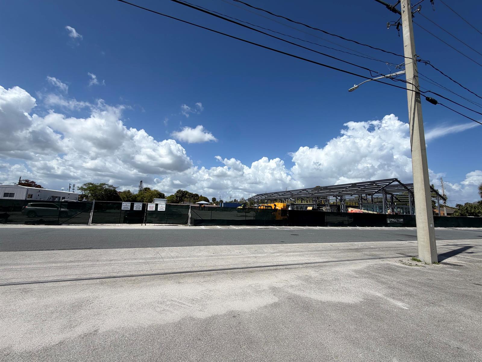 A construction site features a steel building frame behind a black mesh fence — 705 SE Tarpon Avenue, Stuart FL 34994, STUART, FL