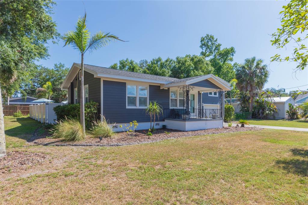 A dark gray single-story house with a front porch sits on a grassy lot — 602 W HILDA STREET, TAMPA, FL