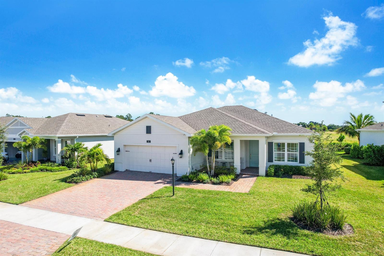 A single-story white house with a brick driveway and a two-car garage — 56 Judah Lane, Sebastian FL 32958, SEBASTIAN, FL