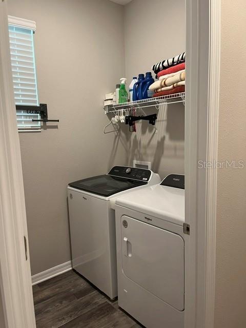 A laundry room features a white washer and dryer beneath a wire storage shelf — 7285 SW 86TH COURT, OCALA, FL
