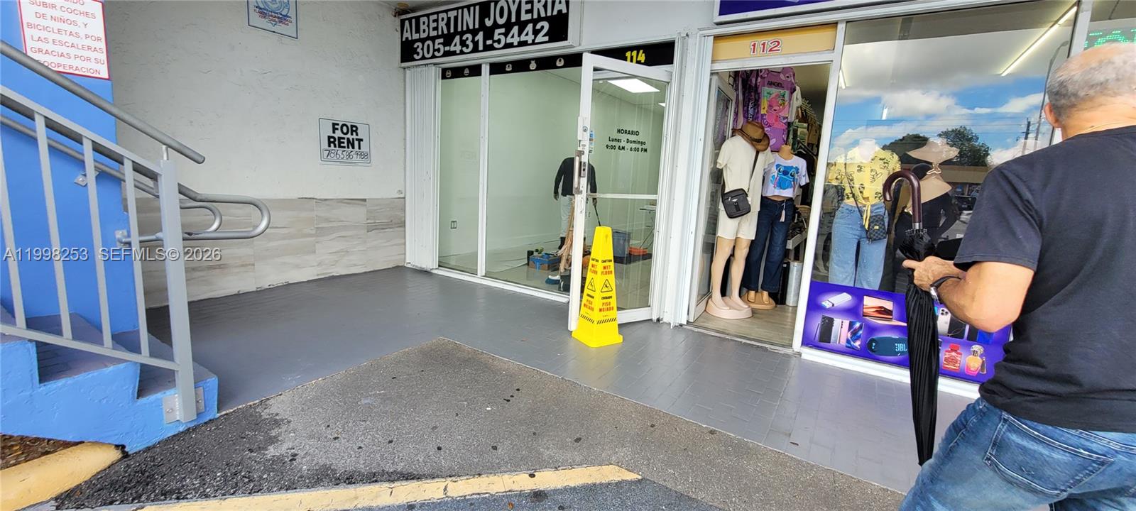An exterior view shows a storefront for rent next to a retail shop with mannequins — 5755 W Flagler St # 114, Miami FL 33144, MIAMI, FL