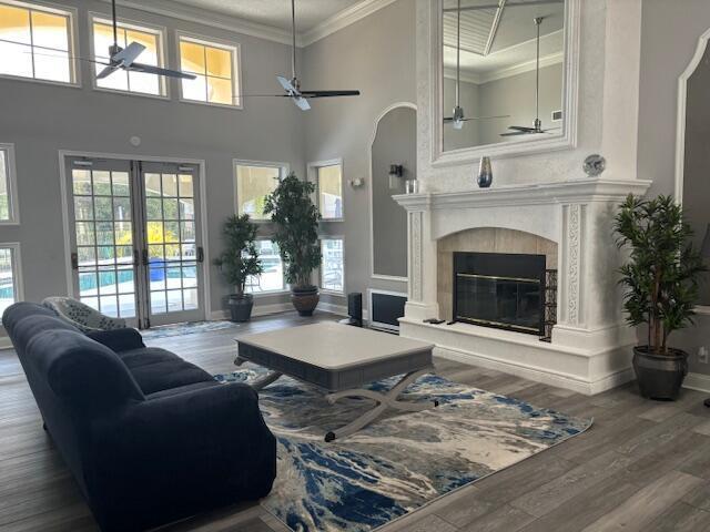 A living room features a fireplace, a large area rug, and double doors leading outside — 815 W Boynton Beach Boulevard # 103, Boynton Beach FL 33426, BOYNTON BEACH, FL