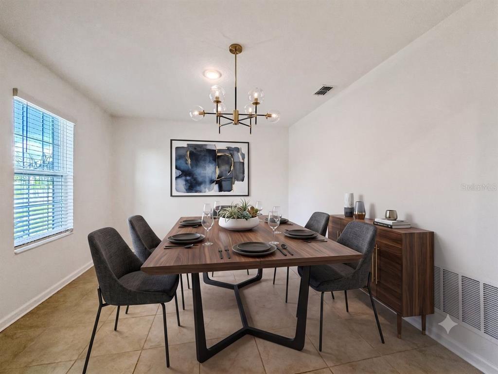 A dining room features a wooden table, six grey chairs, and a modern chandelier — 4459 TAHOE CIRCLE, CLERMONT, FL