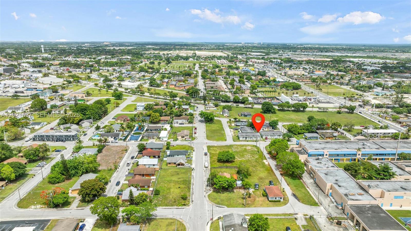 An aerial view shows a residential neighborhood with a red location pin on a building — 651 SW 4th Ave, Homestead FL 33030, HOMESTEAD, FL