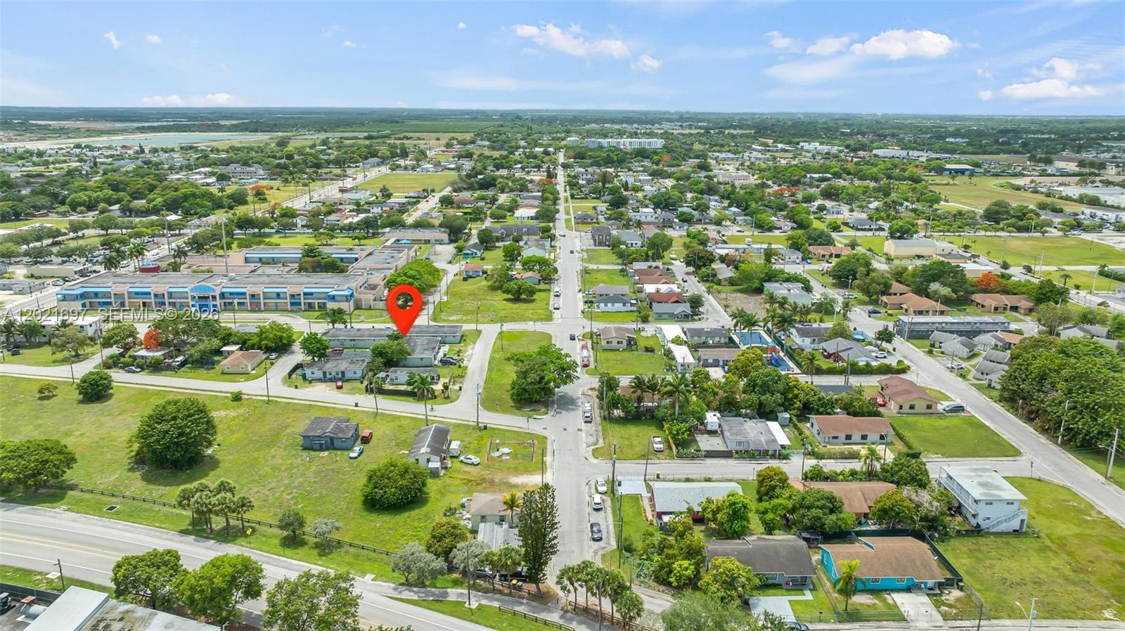 This aerial view shows a residential neighborhood with a red location pin on a building — 651 SW 4th Ave, Homestead FL 33030, HOMESTEAD, FL
