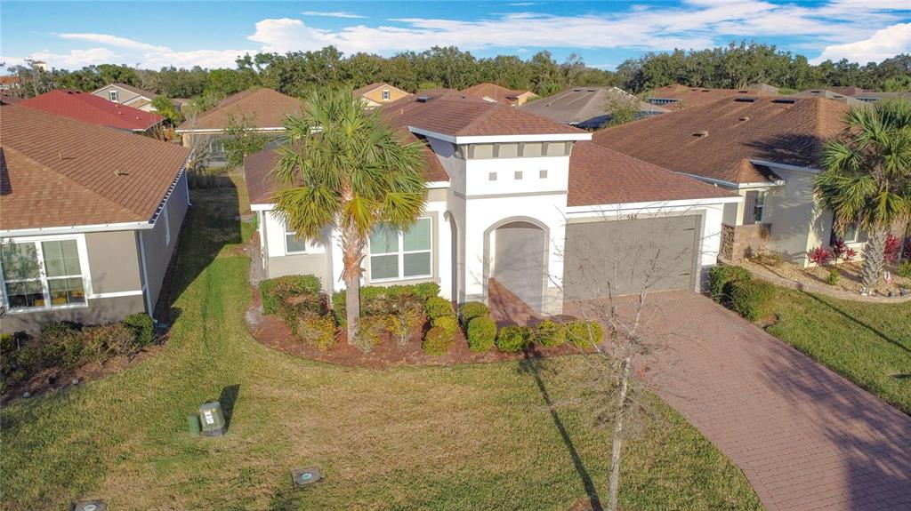An aerial view of a single-story suburban house with a paved driveway and palm tree — 362 VIA TORRENTE DRIVE, KISSIMMEE, FL