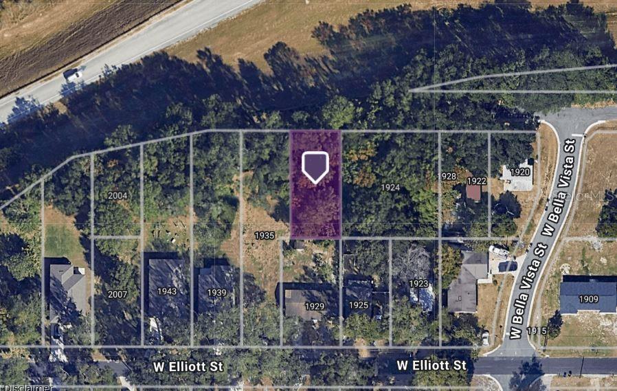This aerial map shows a highlighted vacant lot surrounded by wooded residential properties — 2004 MARGARET STREET, LAKELAND, FL