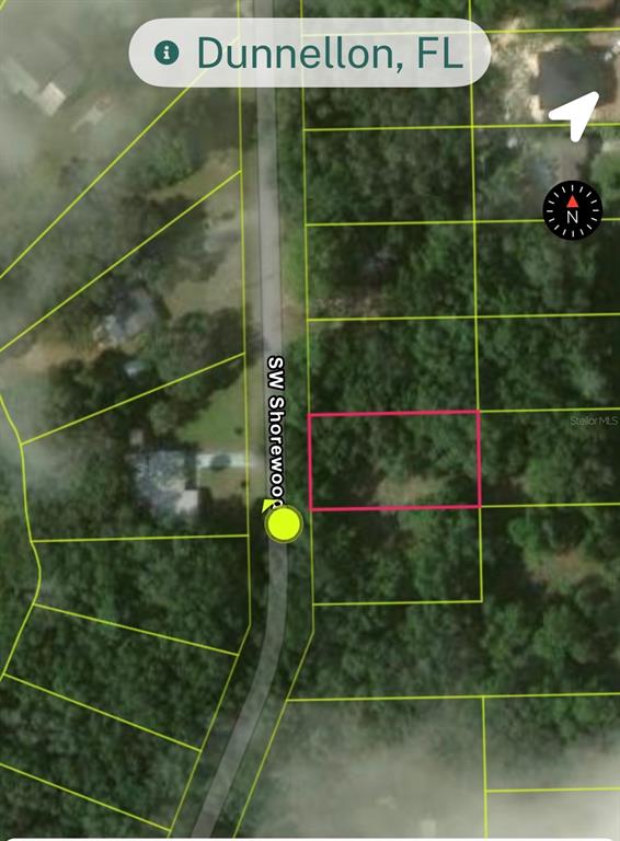 This is a satellite map view showing a vacant, wooded lot highlighted in pink — Lot 15 SW SHOREWOOD DRIVE, DUNNELLON, FL