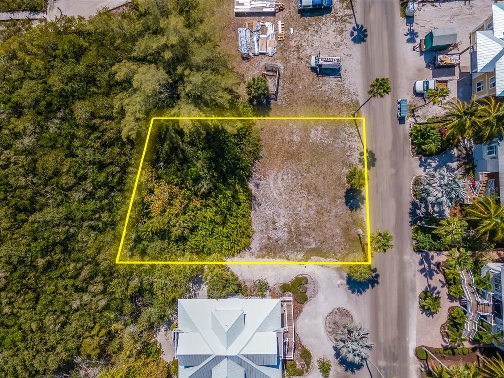 An aerial view shows a vacant rectangular lot outlined in yellow next to a paved road — 7395 PALM ISLAND DRIVE Lot 22, PLACIDA, FL