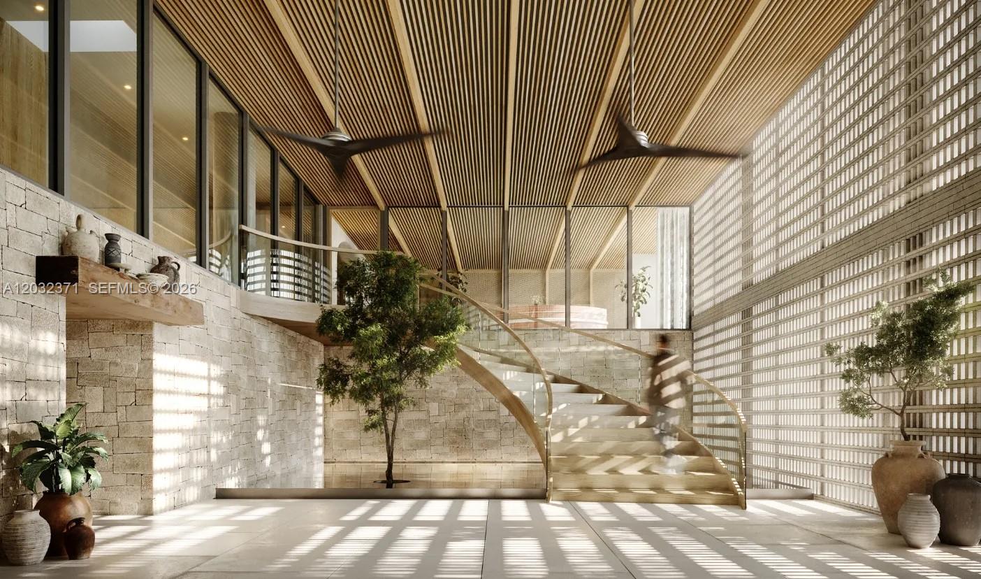 This architectural rendering shows a modern foyer with a curved staircase, stone walls, and slatted ceiling — 1176 97th St # 403, Bay Harbor Islands FL 33154, BAY HARBOR ISLANDS, FL