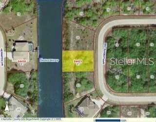 This is a satellite map view showing a highlighted vacant residential lot along a canal — 15666 APPLEWHITE CIRCLE, PORT CHARLOTTE, FL