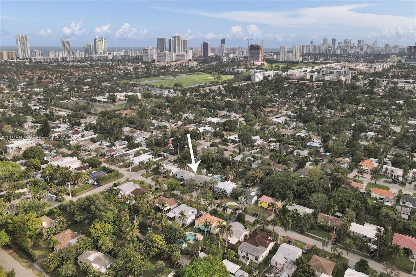 An aerial view shows a suburban neighborhood with a white arrow pointing to a house — 1508 Funston St, Hollywood FL 33020, HOLLYWOOD, FL