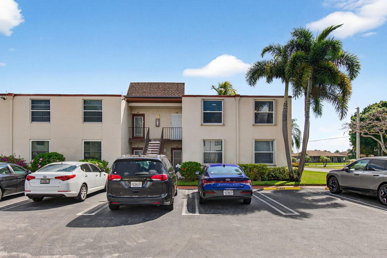 A two-story apartment building with a parking lot in front and a palm tree — 9 Willowbrook Lane # 208, Delray Beach FL 33446, DELRAY BEACH, FL