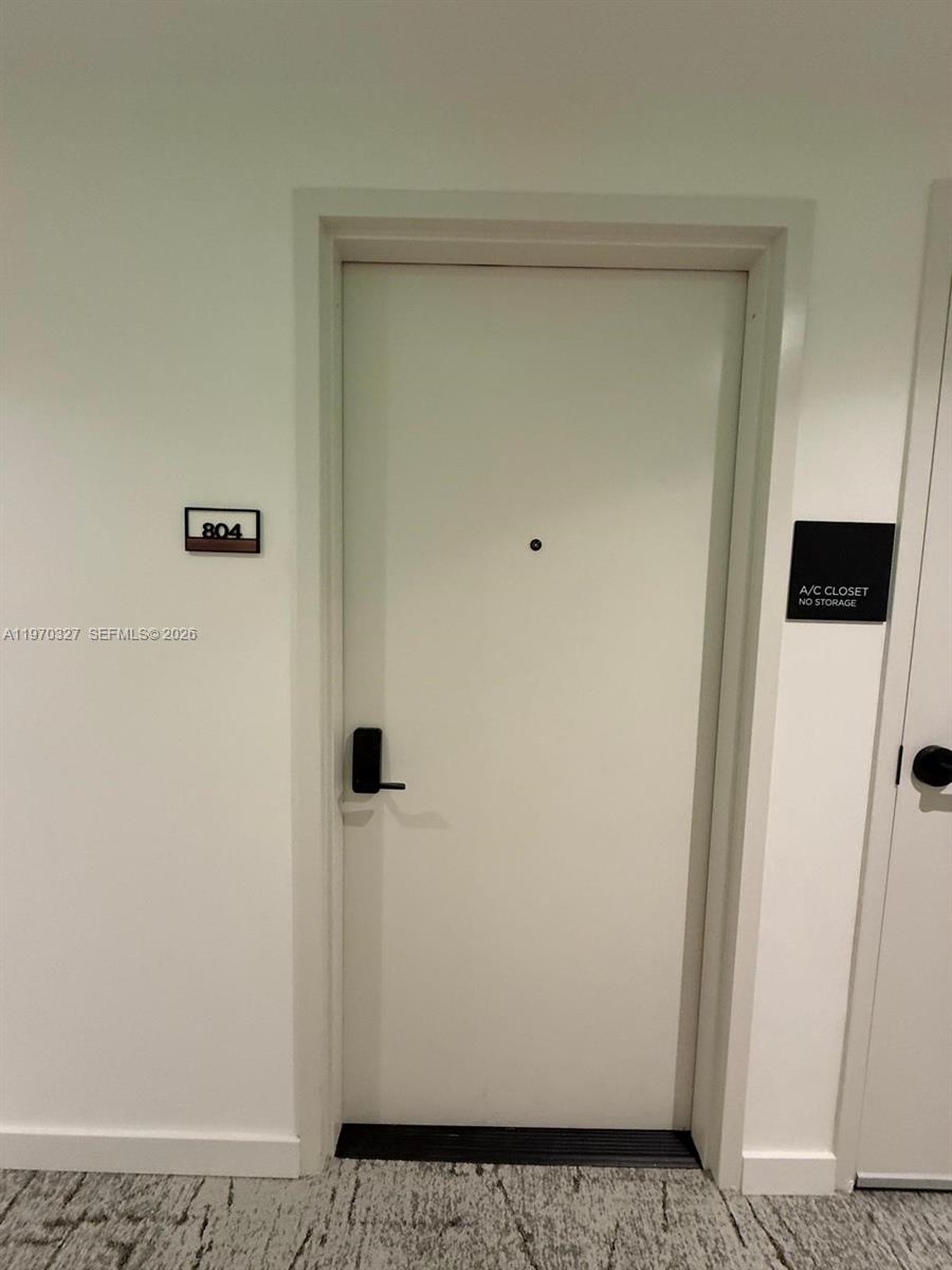 A white apartment door labeled 804 sits next to a sign for an A/C closet — 225 N Miami Ave # 804, Miami FL 33128, MIAMI, FL