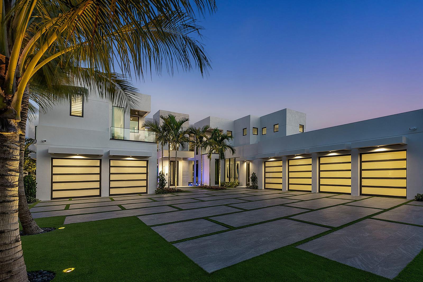 A modern white multi-car garage home exterior with a large paved driveway and palm trees — 372 E Alexander Palm Road, Boca Raton FL 33432, BOCA RATON, FL