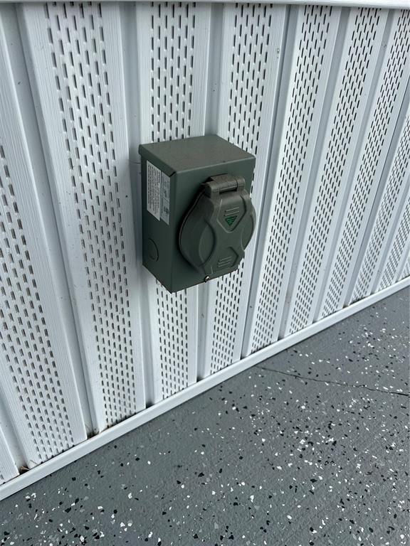 A gray electrical outlet box with a protective cover is mounted on white exterior siding — 137 CITRUS RIDGE DRIVE, DAVENPORT, FL