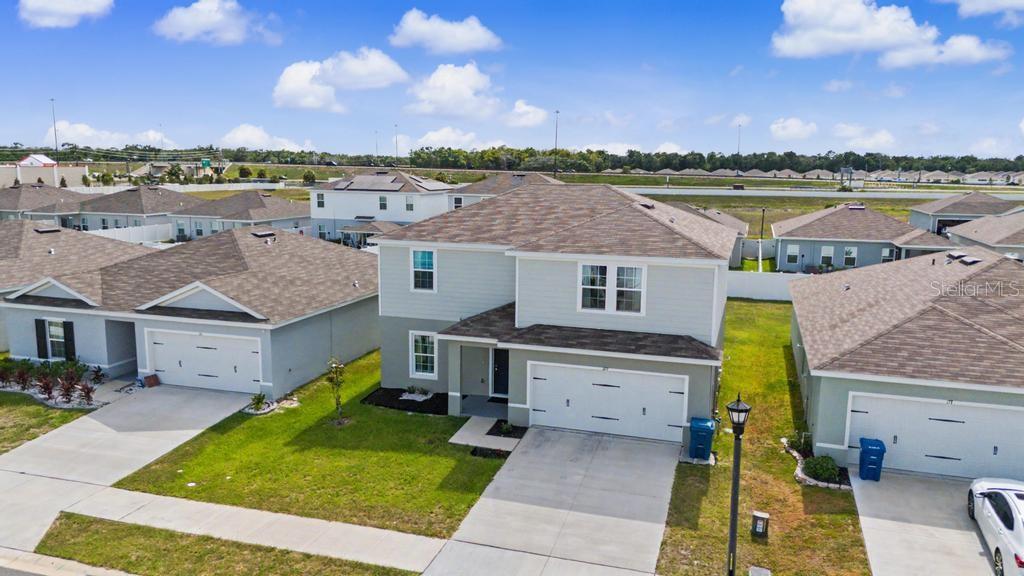 An aerial view shows a two-story suburban house with a garage and a driveway — 169 BORLAND STREET, BROOKSVILLE, FL