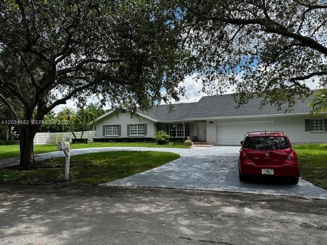 A red car is parked in the driveway of a single-story house with a lawn — 14763 SW 152nd Pl, Miami FL 33196, MIAMI, FL