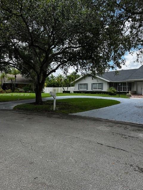 A single-story house with a large tree in the front yard and a paved driveway — 14763 SW 152nd Pl, Miami FL 33196, MIAMI, FL