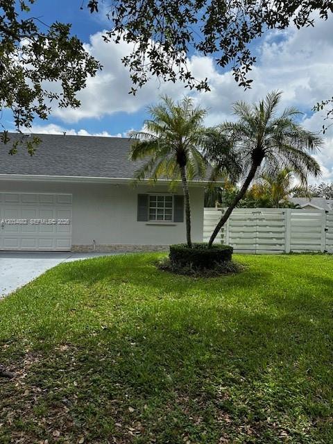 A single-story house with a white garage door, gray siding, and two palm trees — 14763 SW 152nd Pl, Miami FL 33196, MIAMI, FL