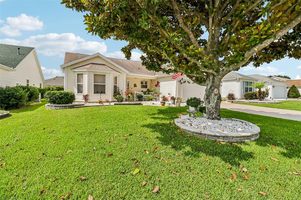 A single-story house with light siding, a two-car garage, and a patterned concrete driveway — 16581 SE 77TH NORTHRIDGE COURT, THE VILLAGES, FL