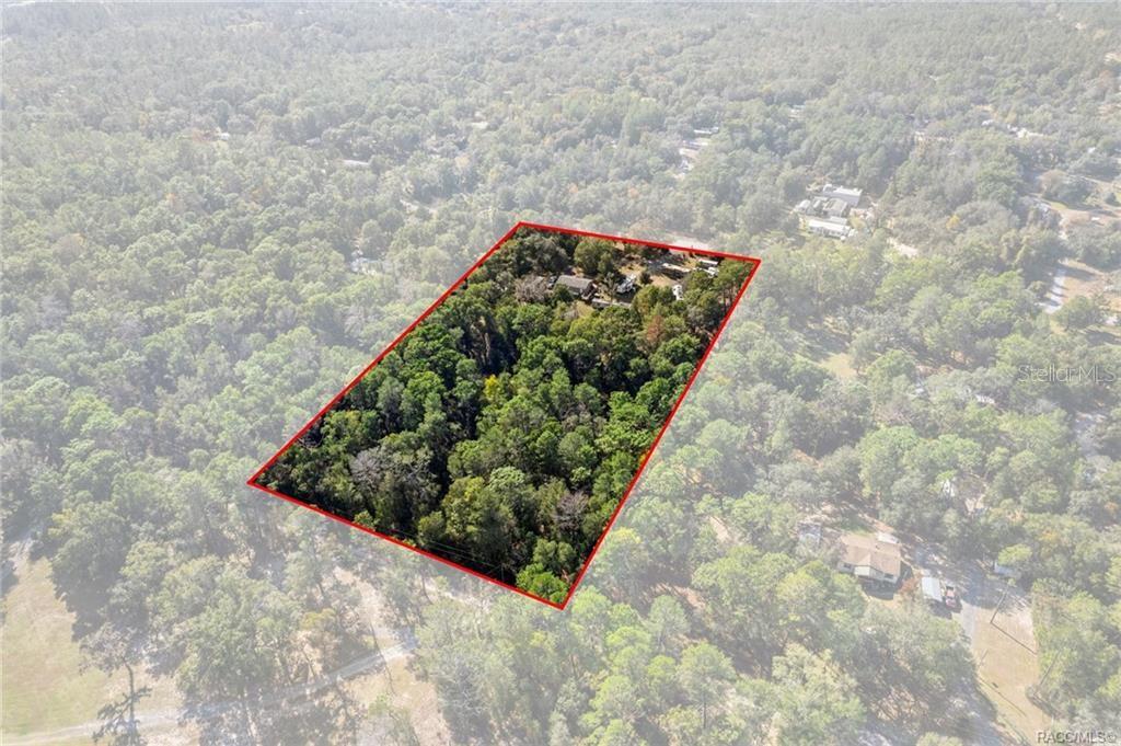 An aerial view shows a rectangular property lot outlined in red within a wooded area — 16362 CHEROKEE ROAD, BROOKSVILLE, FL