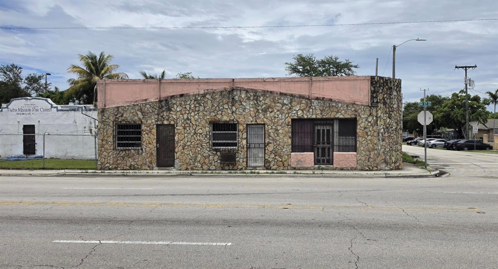 A single-story commercial building with a stone facade and pink trim sits on a corner lot — 4201 NW 17th Avenue, Miami FL 33142, MIAMI, FL