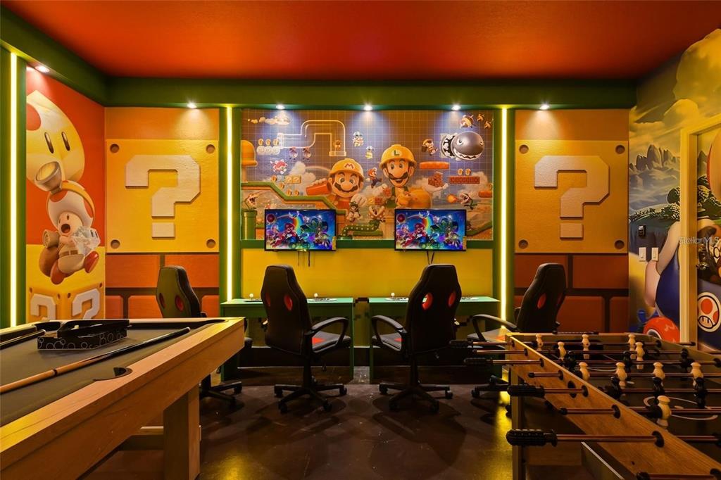 A game room featuring Mario-themed wall murals, two gaming stations, a pool table, and foosball — 3083 MAHALO DRIVE, DAVENPORT, FL