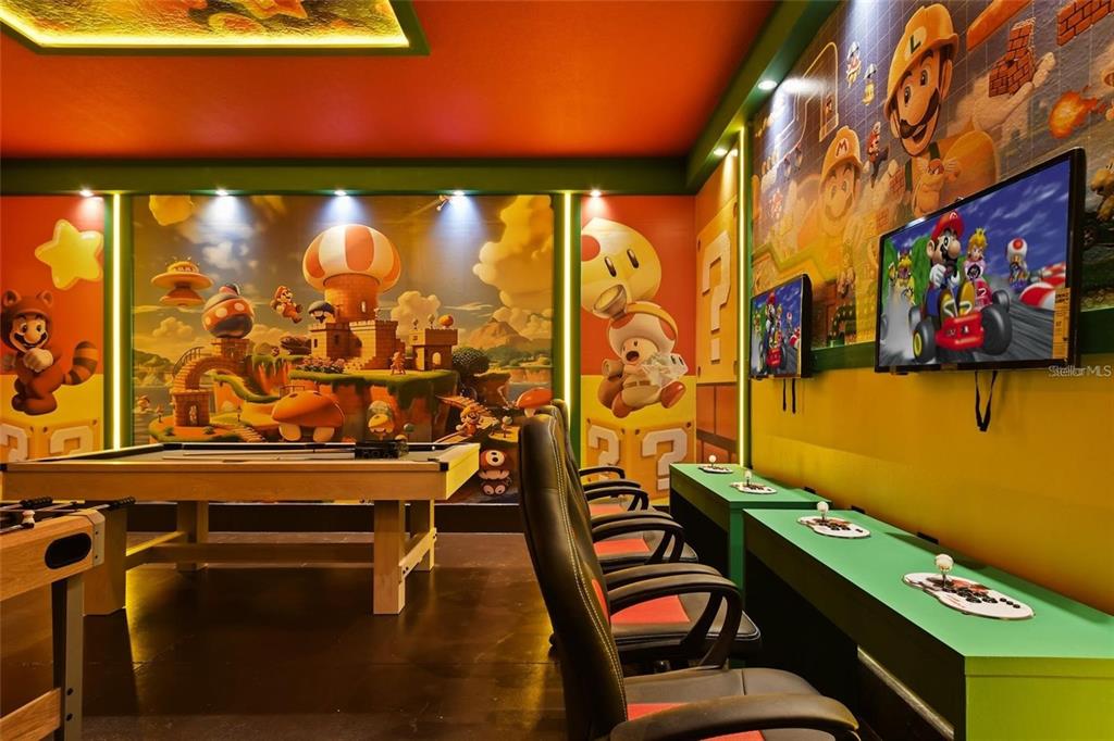 A game room features a pool table, gaming chairs, and walls decorated with Super Mario murals — 3083 MAHALO DRIVE, DAVENPORT, FL