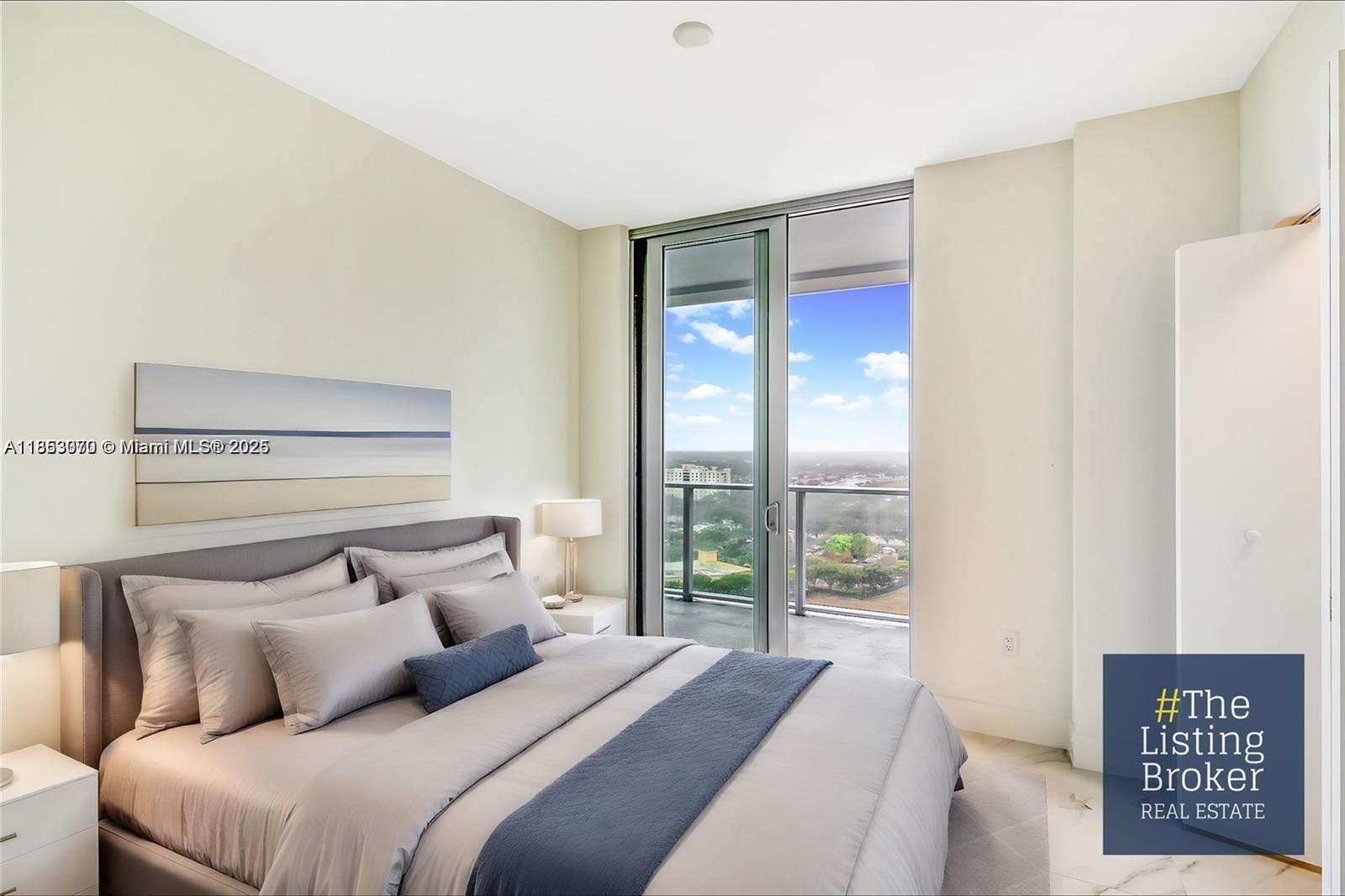 A modern bedroom features a gray bed, white walls, and a balcony with city views — 2000 Metropica Way # 1709, Sunrise FL 33323, SUNRISE, FL