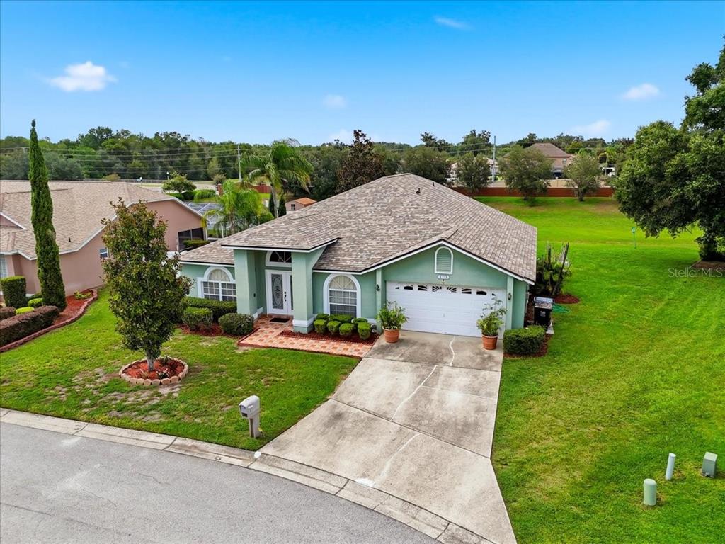 An aerial view of a light green single-story house with a two-car garage and lawn — 6312 PROMINENCE POINT DRIVE, LAKELAND, FL