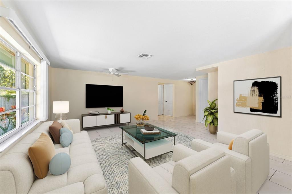 A living room features a white sofa, two armchairs, a glass coffee table, and a television — 12614 LOGAN PLACE, TAMPA, FL