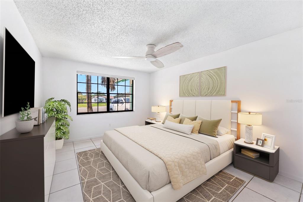 A bedroom features a queen bed, a ceiling fan, a window, and tile flooring — 12614 LOGAN PLACE, TAMPA, FL