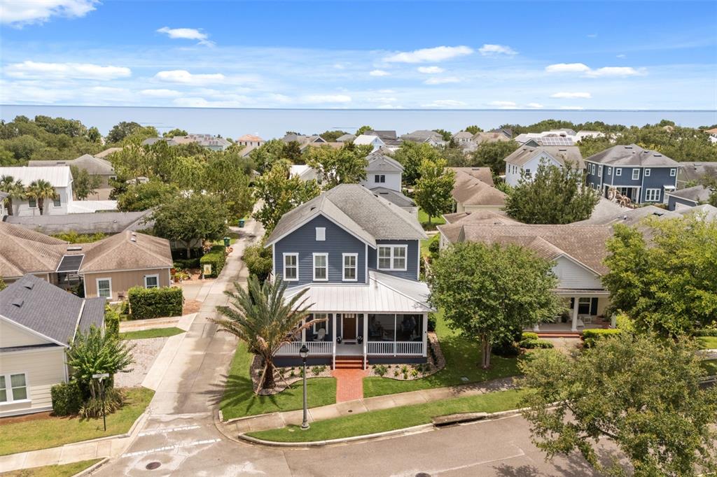 An aerial view shows a blue two-story house with a front porch and metal roof — 925 EASLEY AVENUE, WINTER GARDEN, FL