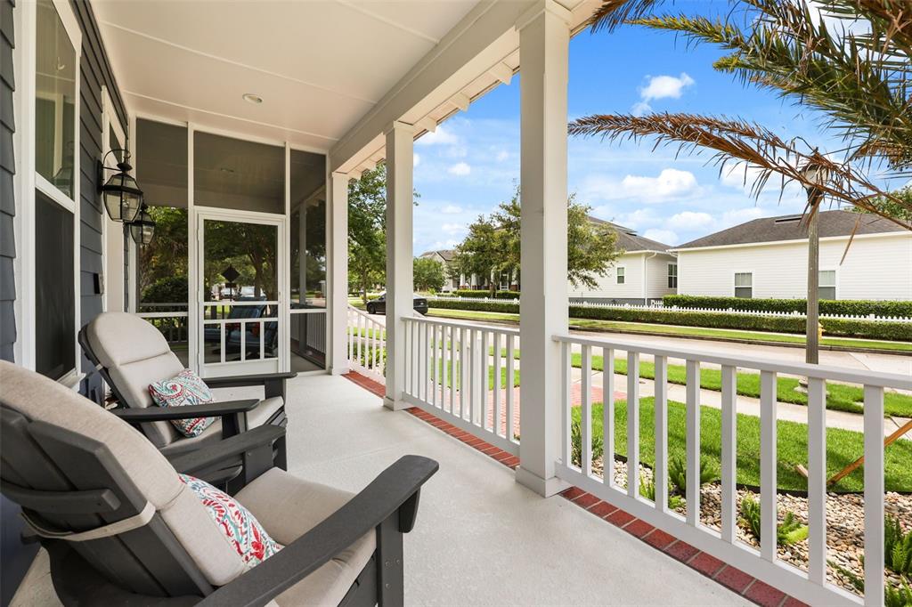 A covered porch features two chairs, a screened door, white railings, and a brick border — 925 EASLEY AVENUE, WINTER GARDEN, FL