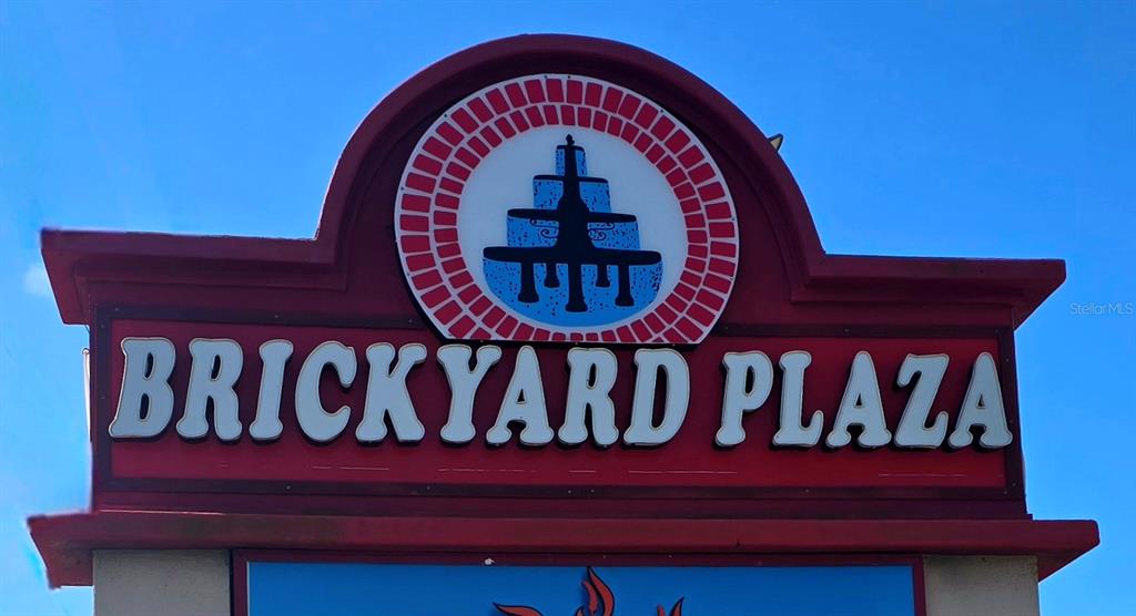 A red sign for Brickyard Plaza features a circular logo with a fountain illustration — 530 US-41-BYP UNIT 20-21B, VENICE, FL