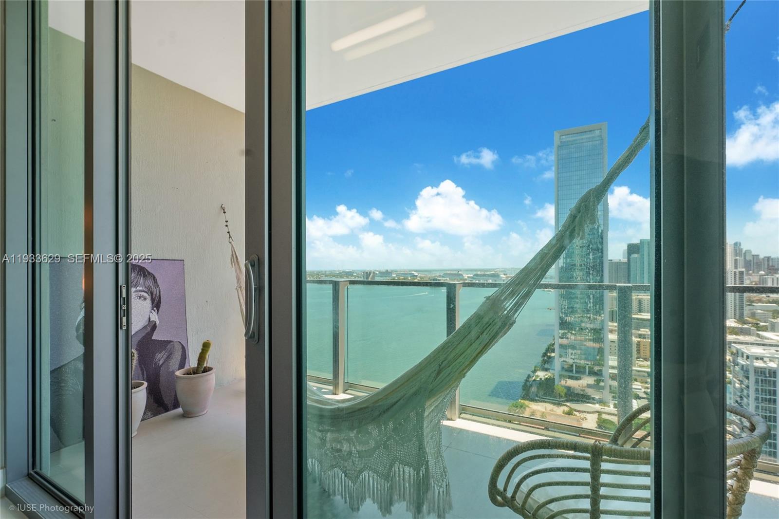 A balcony with a hammock and a view of the ocean and city skyline — 2900 NE 7th Ave # 3108, Miami FL 33137, MIAMI, FL