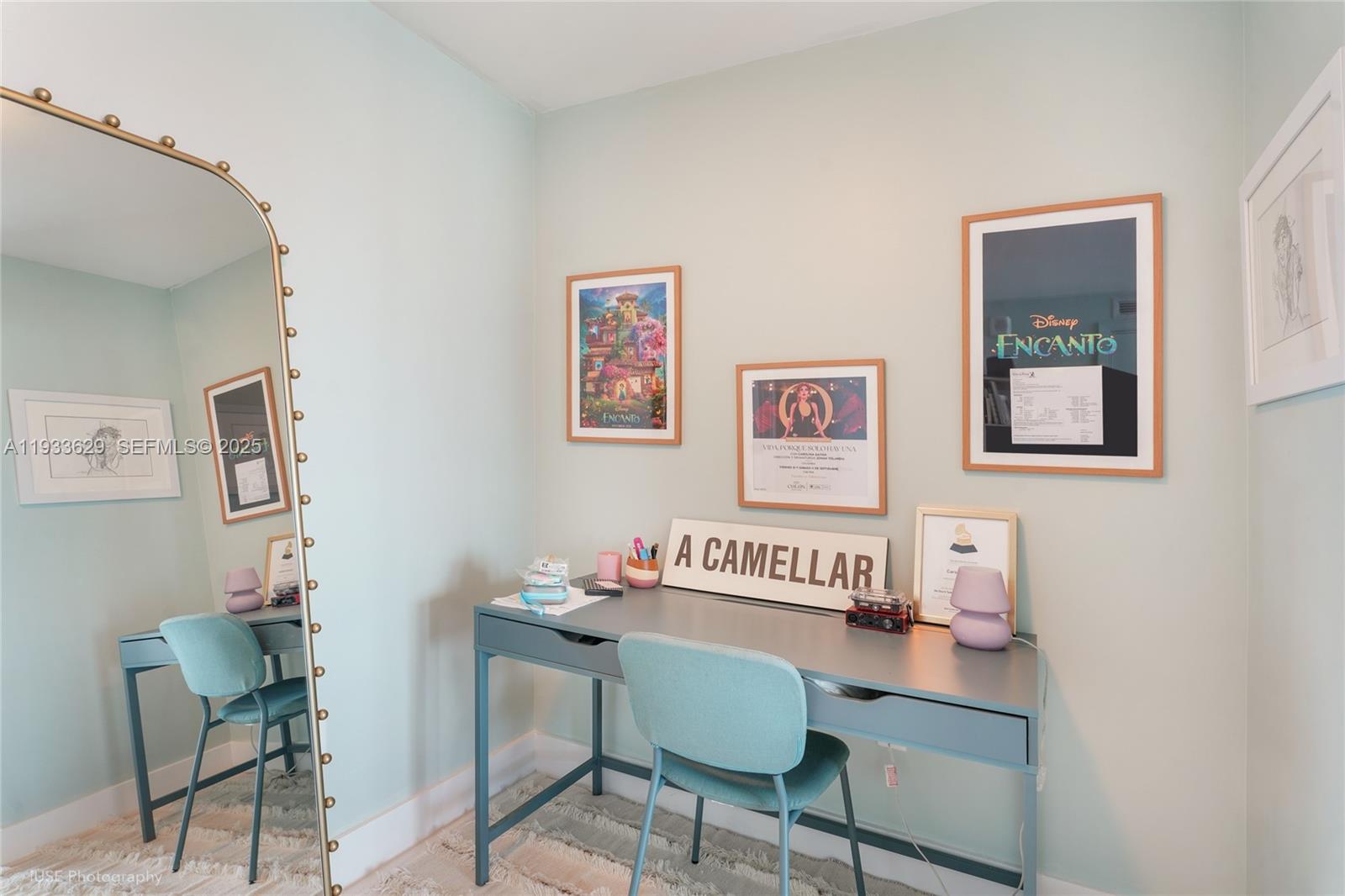 A desk with a chair sits in a room with light blue walls and framed art — 2900 NE 7th Ave # 3108, Miami FL 33137, MIAMI, FL